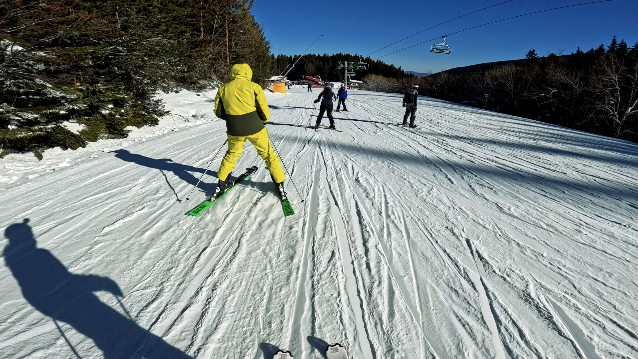Skier descending a snowy mountain slope